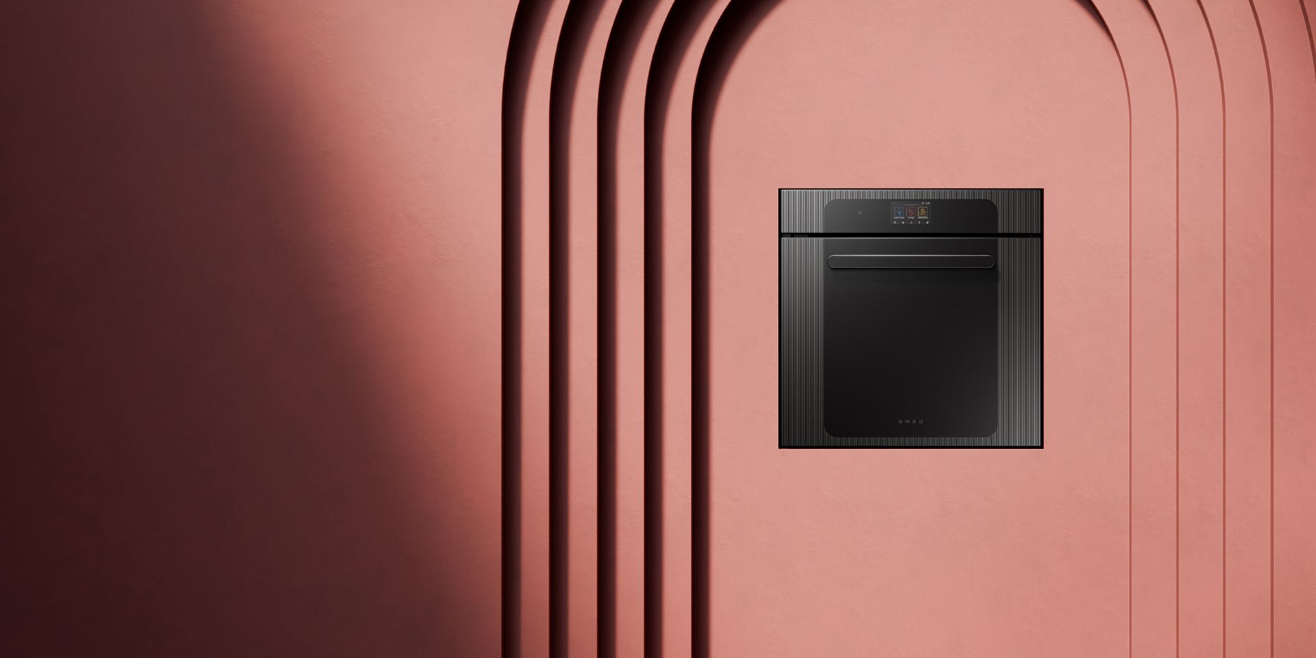 A sleek, built-in black oven installed in a terracotta-colored wall with minimalist architectural arches.